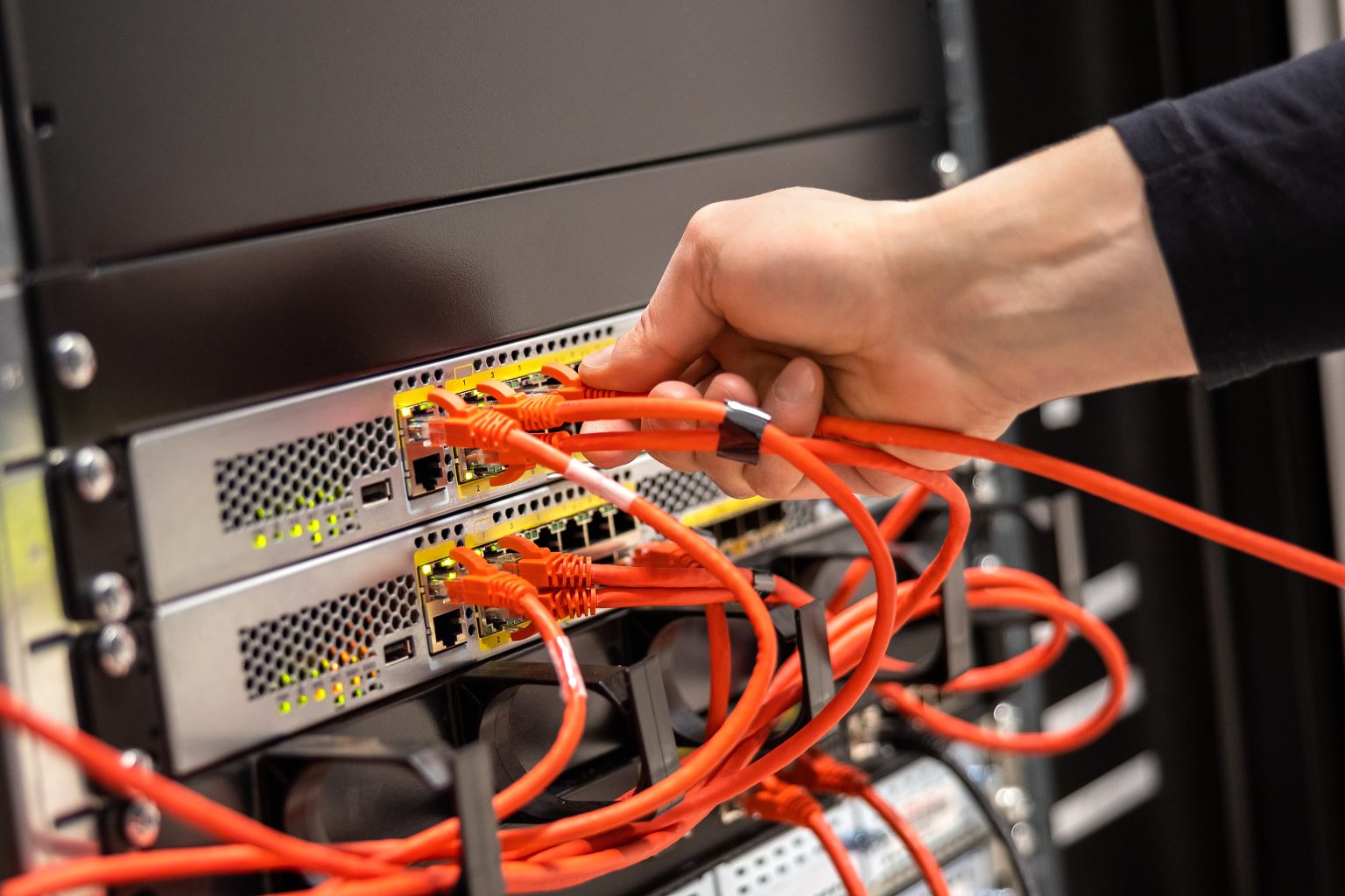 Technician connecting a network cable